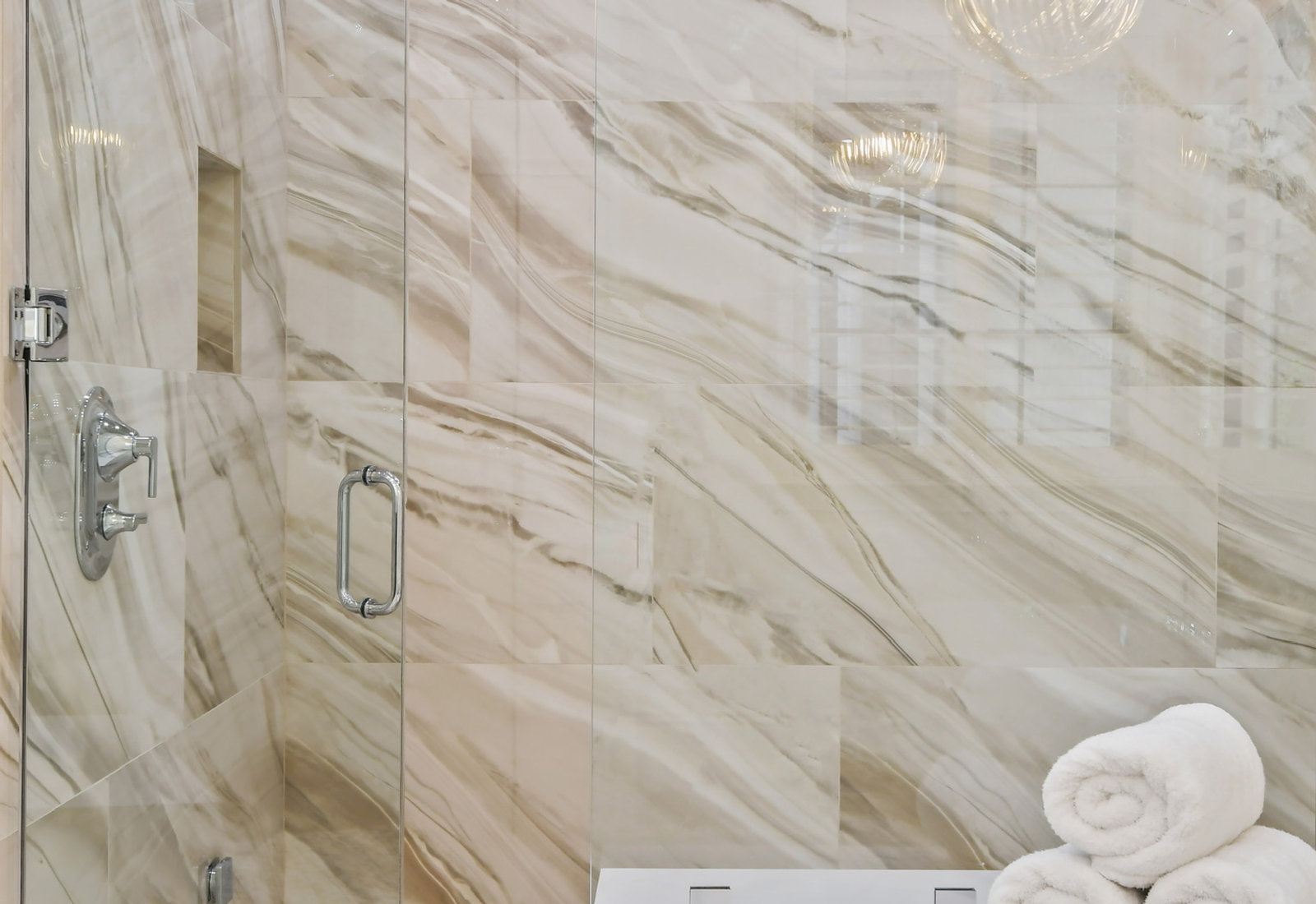 Primary bath with full-slab marble shower surround