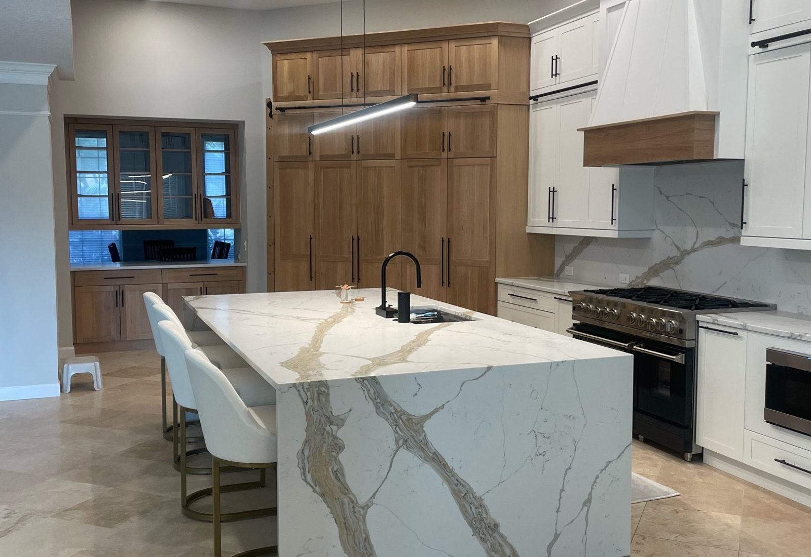 Custom kitchen with calacatta marble waterfall island